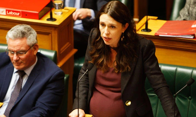 New Zealand Prime Minister Jacinda Ardern, right, addresses Parliament in Wellington, New Zealand. (AP)