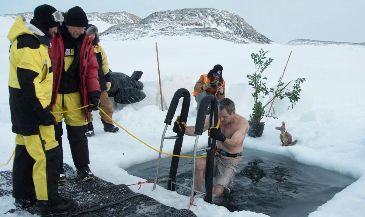 A researcher takes a dip in a swimming hole prepared at the Casey research station to welcome the winter solstice in this photo released by the Australian Antarctic Division on Thursday, June 21. (Australian Antarctic Division/AFP)