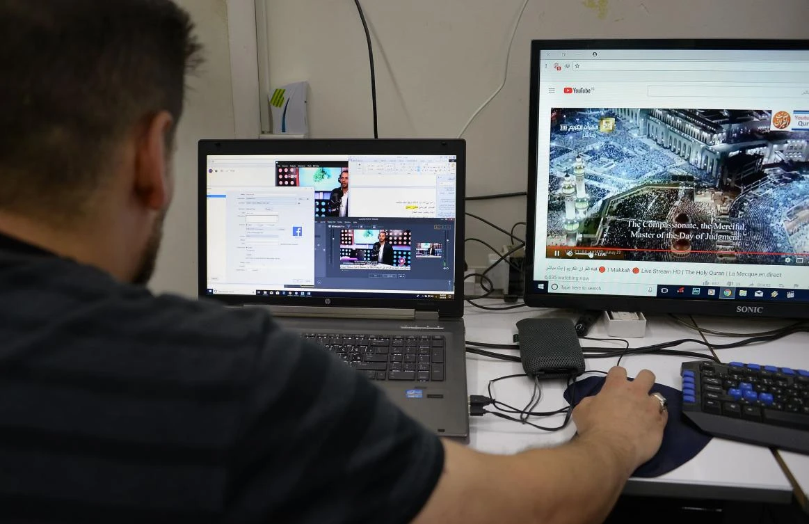 A technician follows the broadcasting of a program on One FM, a radio station in the northern Iraqi city of Mosul. The emergence of stations such as One FM is a step in the city’s transformation since Daesh was ousted. (AFP)