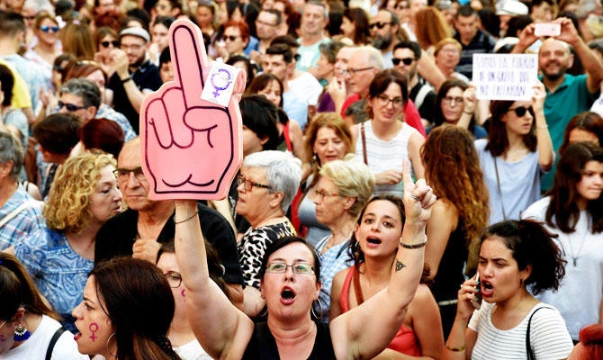 Demonstrators shout slogans as they take part in a protest rally in Valencia on June 22, 2018, a day after a court ordered the release on bail of five men sentenced to nine years in prison for sexually abusing a young woman at Pamplona's bull-running festival. (AFP)