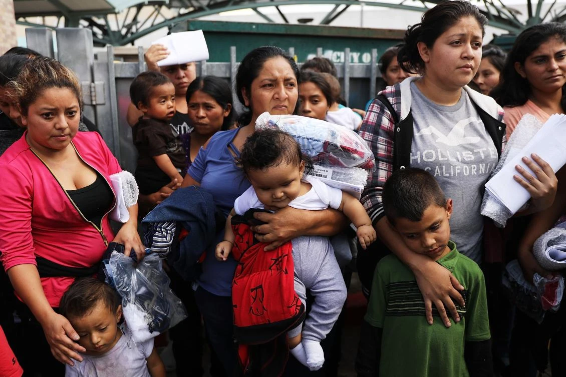 Dozens of women and their children, many fleeing poverty and violence in Honduras, Guatamala and El Salvador, arrive at a bus station following release from Customs and Border Protection on June 22, 2018 in McAllen, Texas. (Spencer Platt/Getty Images/AFP)