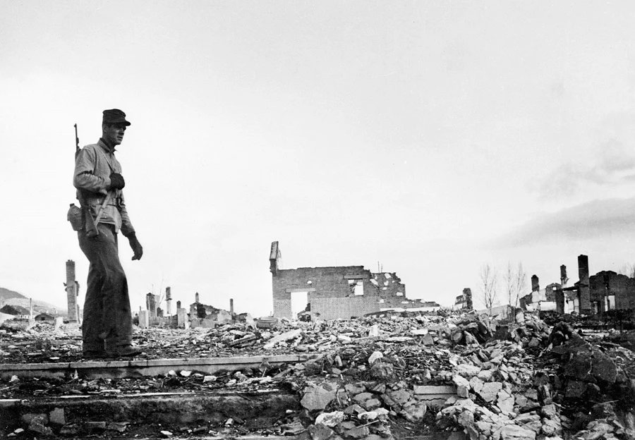 Undated picture taken in Hamhung, Korea, shows an US soldier walking among the ruins of the city (FILE/AFP)