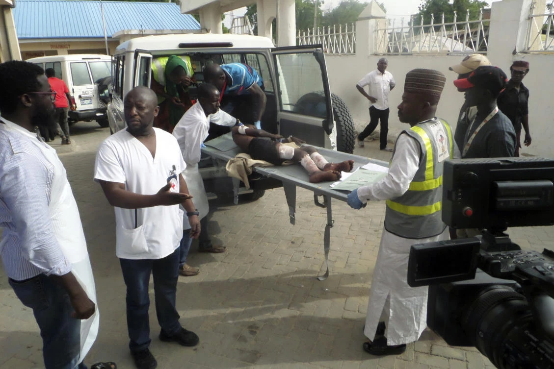 In this photo taken Sunday June 17, 2018, health officials loads an injured person into an ambulance following a suicide attack in Damboa, Borno Nigeria. (AP)