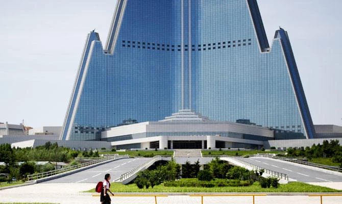 A school girl walks past Ryugyong Hotel in Pyongyang, North Korea, June 22, 2018. (AP)