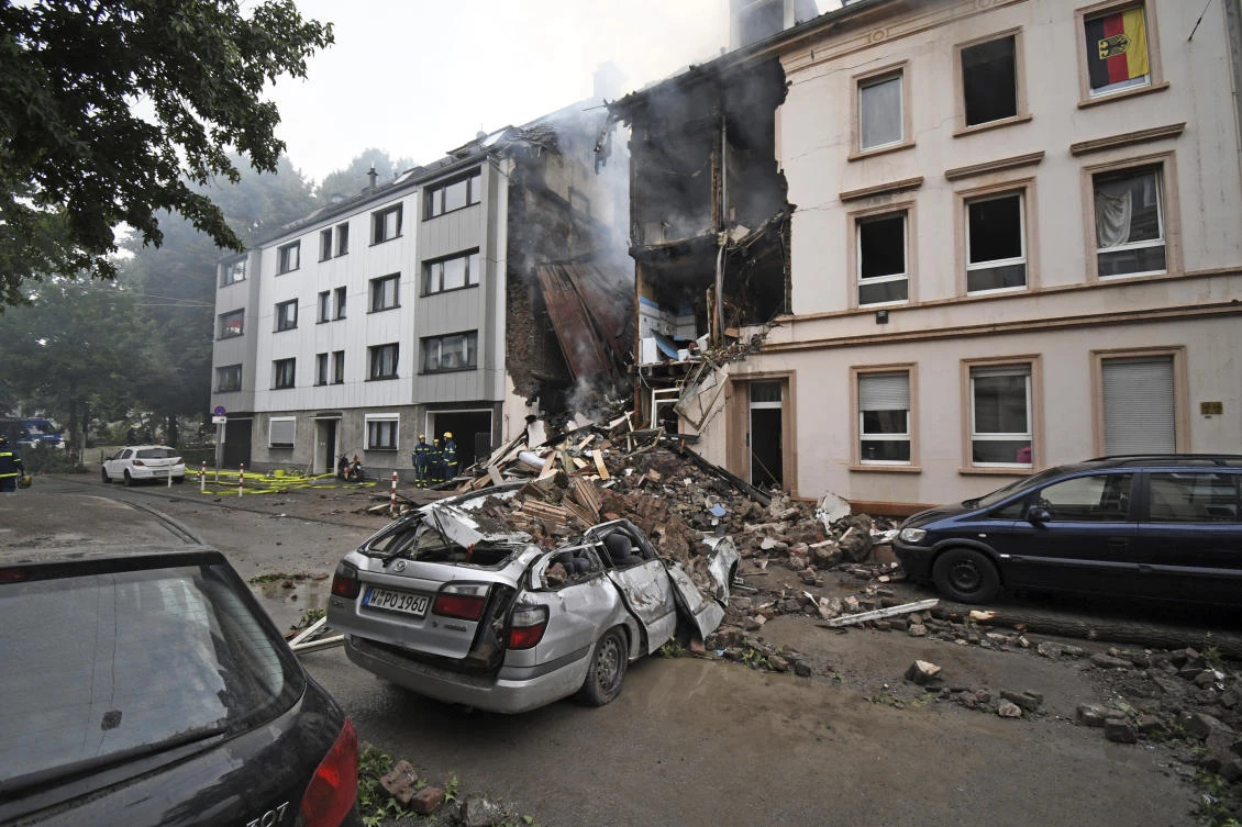A car and a house are destroyed after an explosion in Wuppertal, Germany, June 24, 2018. German police say 25 people were injured, when an explosion destroyed a several-store building in the western city of Wuppertal. (Henning Kaiser/dpa via AP)