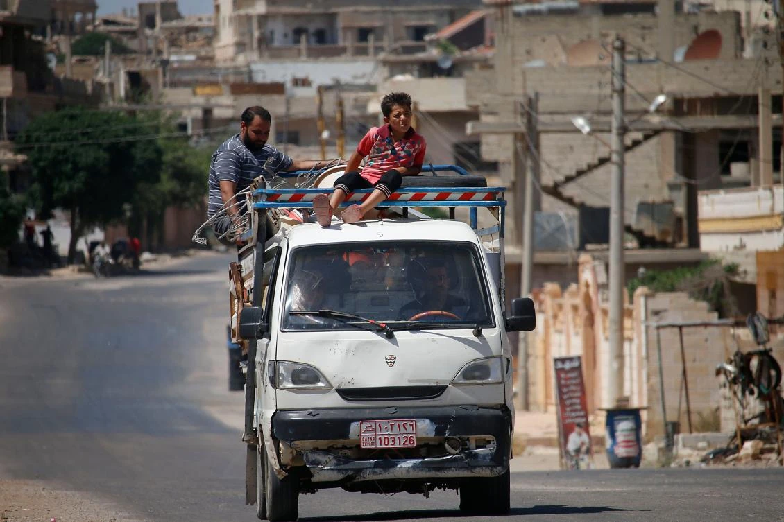 Syrian civils leave Daraa, southwestern Syria, after several days of intensified bombardment on June 23, 2018. (AFP)