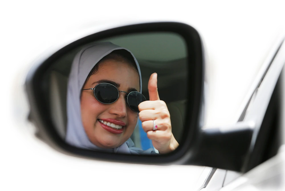 Zuhoor Assiri gestures as she drives her car in Dhahran on Sunday. (Reuters)