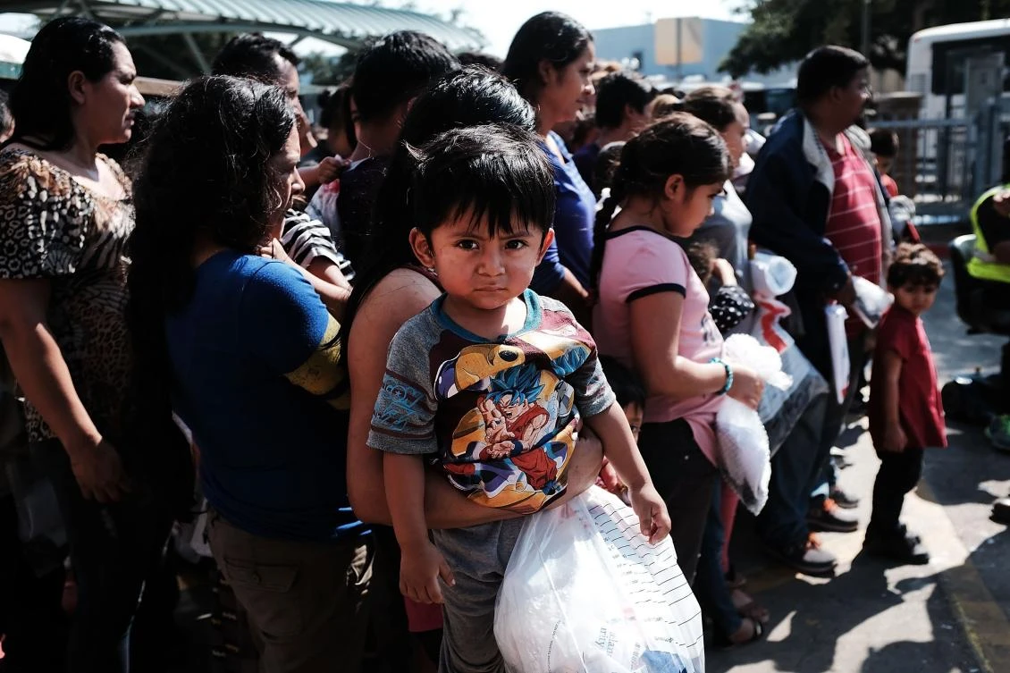 Dozens of women, men and their children, many fleeing poverty and violence in Honduras, Guatamala and El Salvador, arrive at a bus station following release from Customs and Border Protection on June 23, 2018 in McAllen, Texas. (AFP)