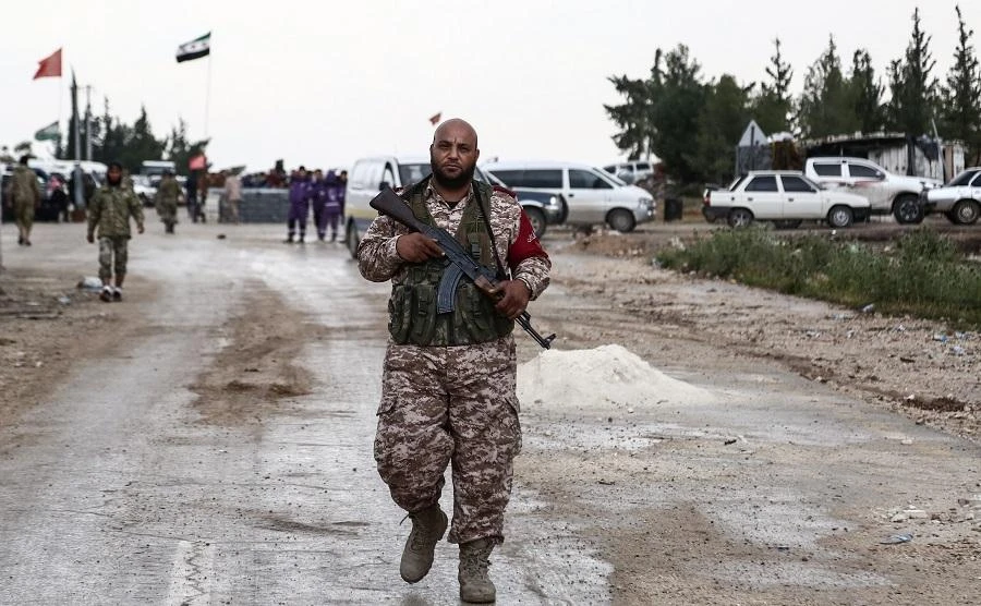 A Turkey-backed Syrian fighter walks in Abu al-Zandin checkpoint near al-Bab in northern Syria on May 8, 2018. (File Photo: AFP)
