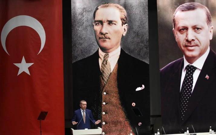 Prime Minister Recep Tayyip Erdogan makes a speech in front of portraits of himself, right, and Mustafa Kemal Ataturk. Erdogan is poised to take on extensive new executive powers following his outright election victory in Sunday’s poll. (Getty Images)