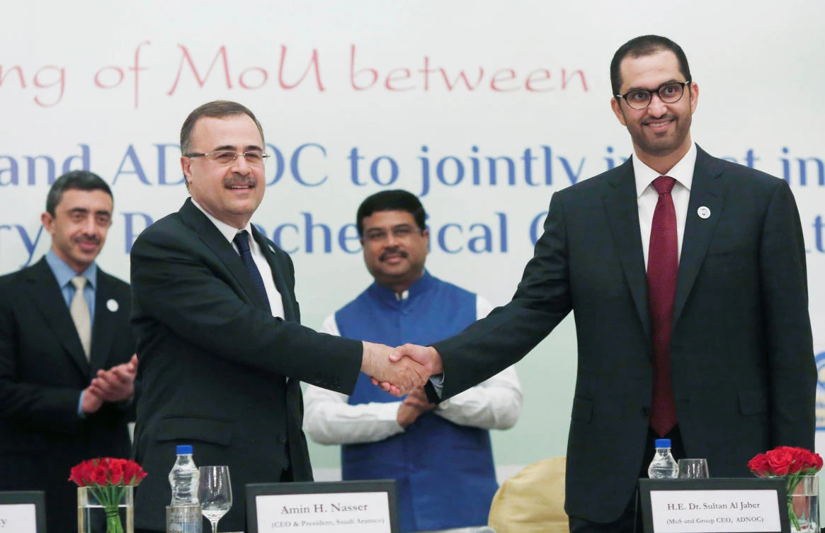 Saudi Armco CEO Amin Nasser shakes hands with ADNOC CEO Ahmed Al-Jaber after signing a deal at an event in New Delhi. (Reuters)