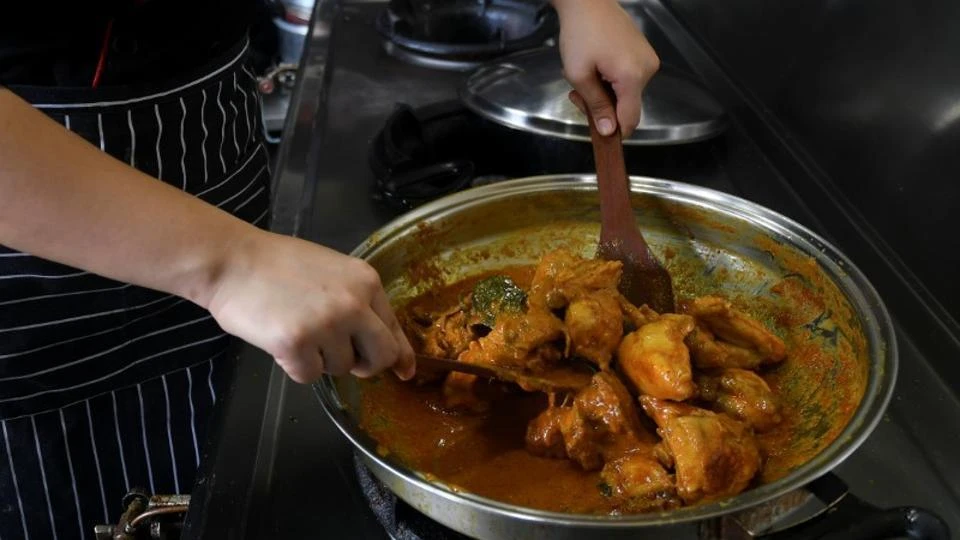 A chef cooks chicken rendang at a restaurant in Cyberjaya, Malaysia. The country’s Human Resource Minister M. Kulasegaran called for foreign cooks to be banned from the country. (Reuters)