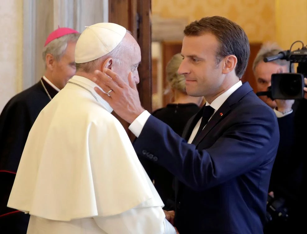 French President Emmanuel Macron (R) greets Pope Francis at the end of a private audience at the Vatican on June 26, 2018. (AFP )