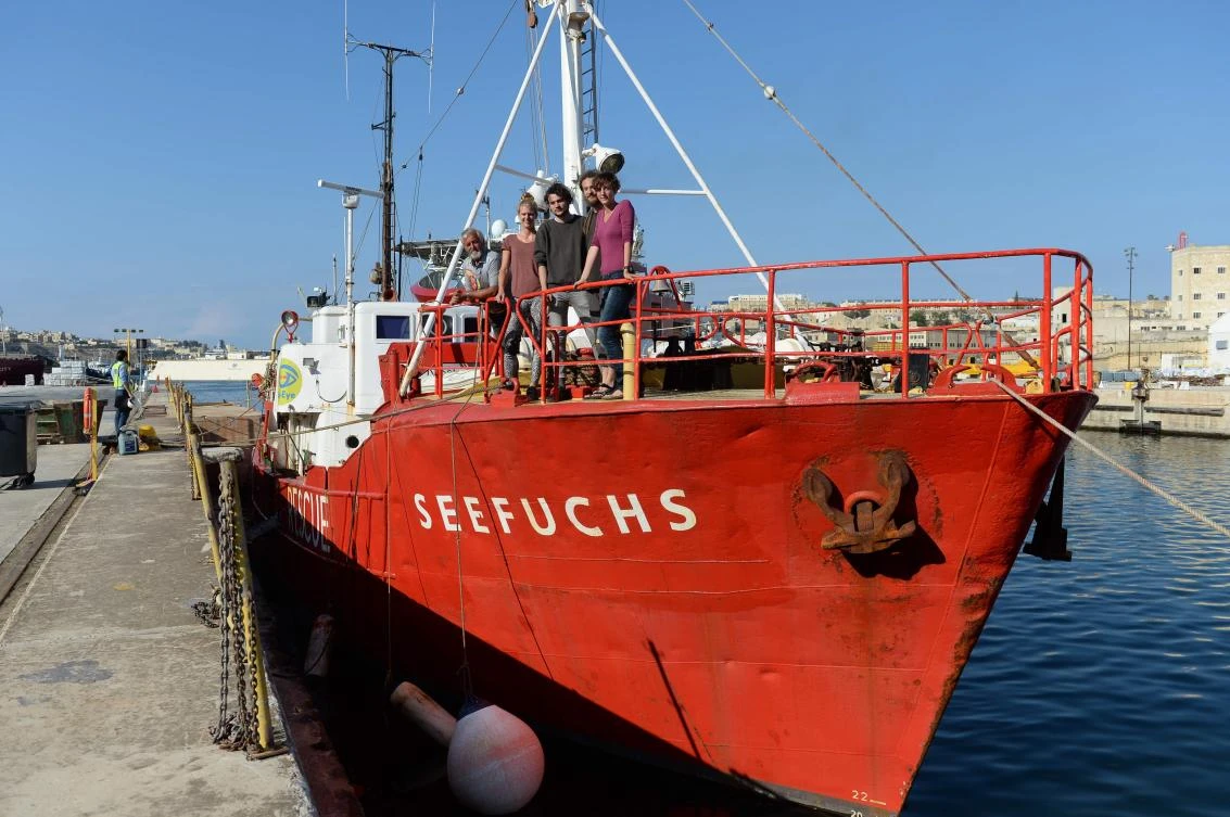 Engineer, Franz Poling (L) and members of the crew stand aboard the Dutch search and rescue vessel Seefuchs, as it lies berthed in a dock in Marsa, Malta on June 25, 2018 after being called back to port. (AFP) /