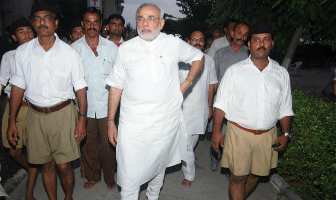 In this Sept. 6, 2009 photo, Gujarat state Chief Minister Narendra Modi, center, leaves after a meeting with Mohan Bhagwat, chief of the Hindu radical Rashtriya Swayamsevak Sangh (RSS), the parent body of the Bharatiya Janata Party (BJP), at a temple in Adalaj, about 20 kilometers (12 miles) north of Ahmadabad, India. (AP)