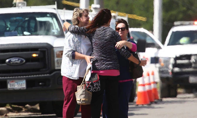 People hug near Coryell Memorial Healthcare System hospital where an explosion in a building under construction injured several people, and knocked power out for a large portion of the city, on Tuesday, in Gatesville, Texas. (AP)