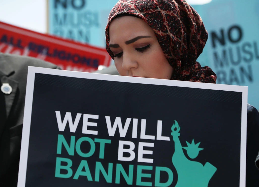 A women participates in demonstration against US President Trump's travel ban as protesters gather outside the US Supreme Court following a court issued immigration ruling June 26, 2018 in Washington, DC. (AFP)