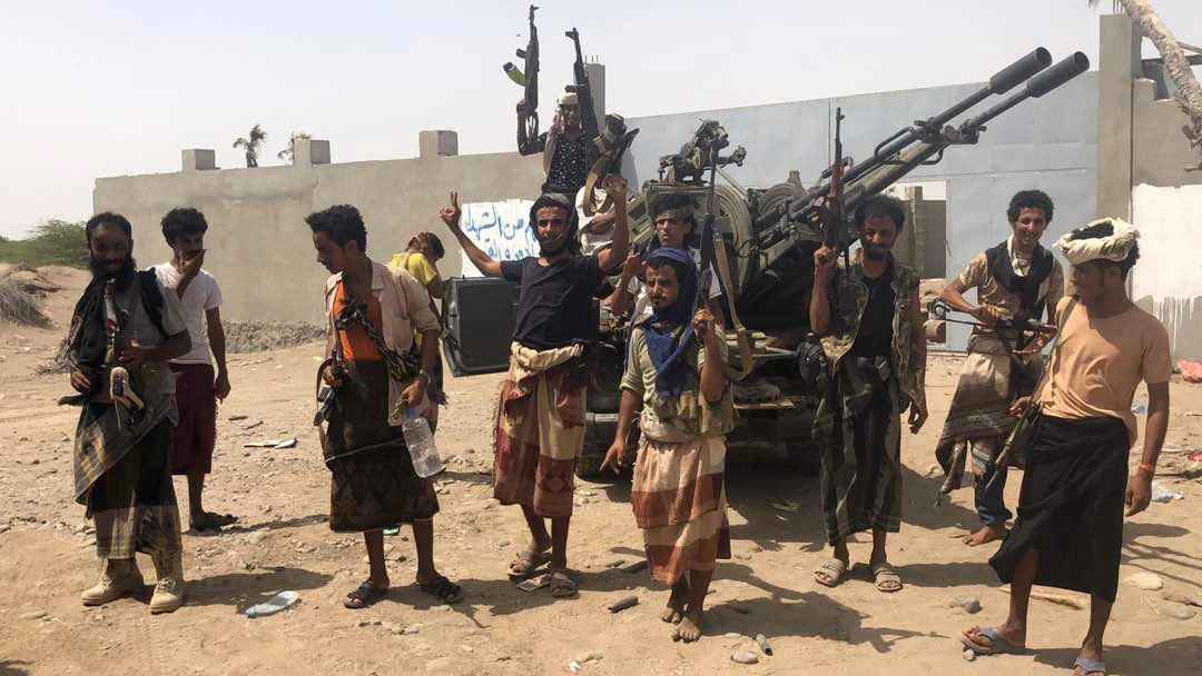 Yemeni pro-government forces backed by the Saudi-led Arab military alliance gather during their fight against Houthi rebels in the area of Hodeida's airport on June 18, 2018. (AFP)