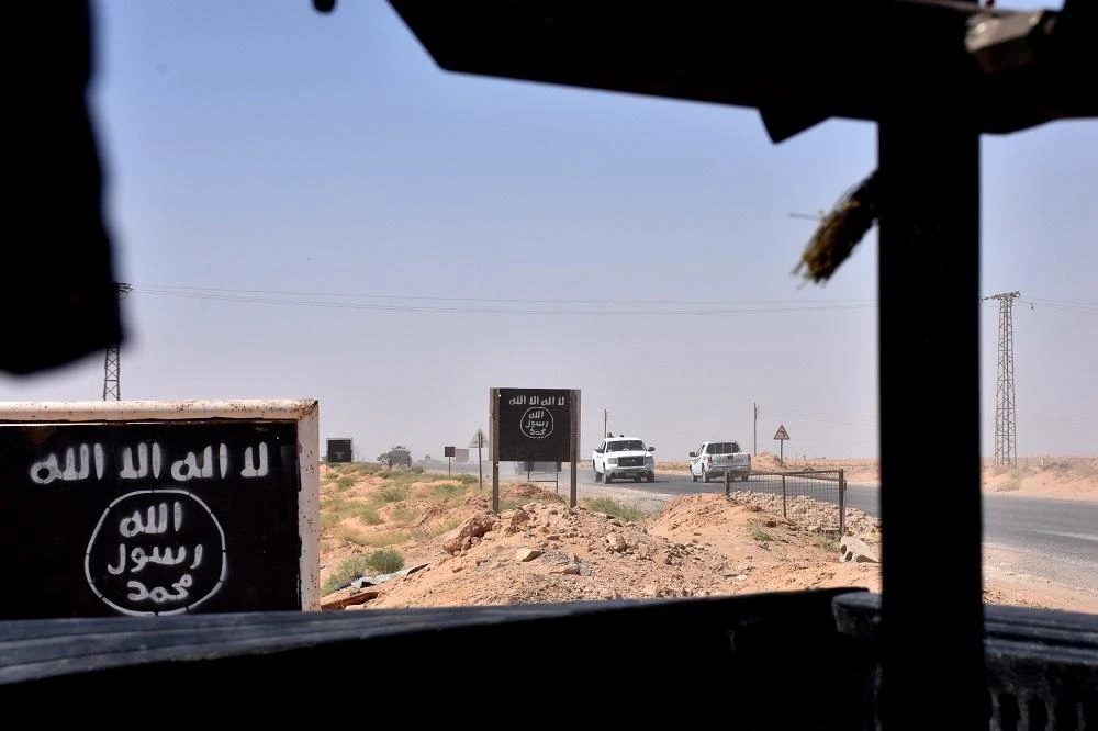 Billboards show the logo of the Daesh group near the village of al-Maleha, in the northern countryside of Deir Ezzor. (File photo: AFP)