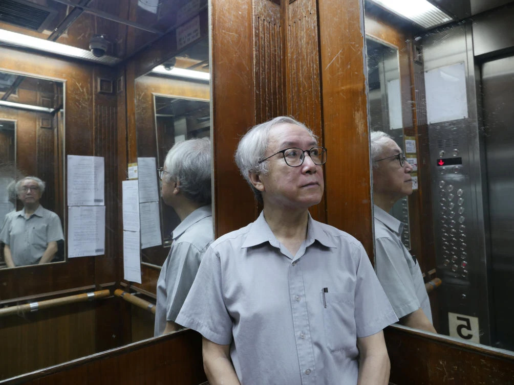 Landlord Ng Goon-lau, 66, poses inside a lift of a building where two suicides have taken place in his property, in Hong Kong, China June 8, 2018. Picture taken June 8, 2018. REUTERS/Venus Wu