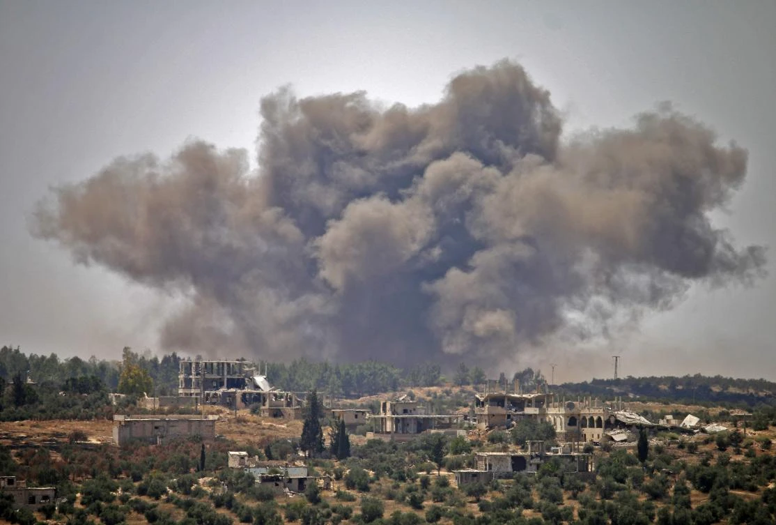 Smoke rises above opposition held areas of the city of Daraa during airstrikes by Syrian regime forces on June 28, 2018. (AFP)