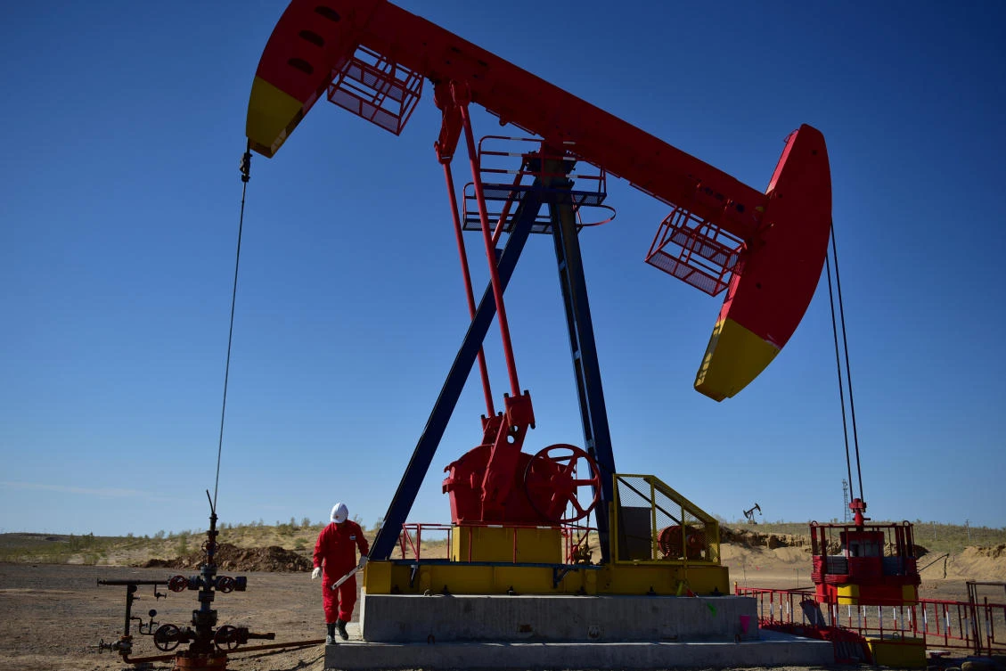 A worker inspects a pump jack at an oil field in Tacheng, Xinjiang Uighur Autonomous Region, China June 27, 2018. (Reuters)