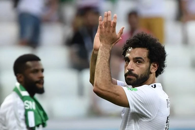 Mohamed Salah, Egypt’s beloved striker, greeted an adoring crowd who turned up at his doorstep after his Cairo address was leaked on Facebook. (AFP)