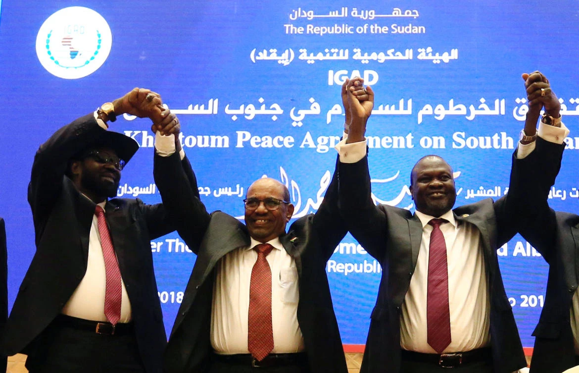 From left: South Sudan President Salva Kiir, Sudan’s President Omar Al-Bashir and South Sudan rebel leader Riek Machar hold hands after signing a peace agreement in Khartoum on June 27, 2018. (Reuters)