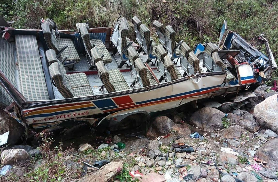 Passengers’ belongings are scattered after the overcrowded bus fell into a gorge in the northern state of Uttarakhand, which killed at least 30 people. (State Dizater Response Found via AFP)