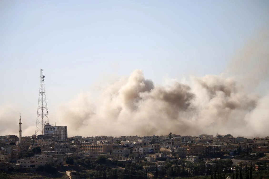 Smoke rises above rebel-held areas of the city of Daraa during airstrikes by Syrian regime forces on Saturday, June 30. (AFP)