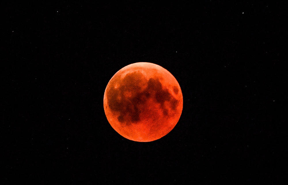 This picture shows the full moon during a 'blood moon' eclipse as seen from the eastern Turkey city of Tunceli on July 27, 2018. (AFP / BULENT KILIC)