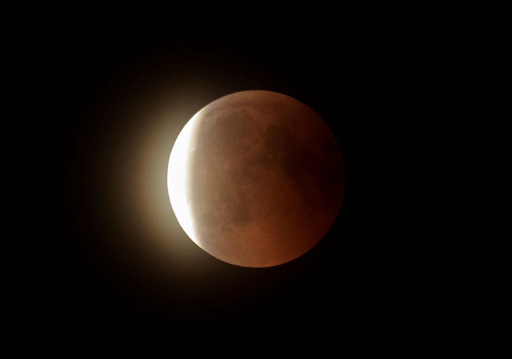 The Moon leaves the shadow of Earth during a full lunar eclipse over Vienna, Austria, on July 27, 2018. (REUTERS/Heinz-Peter Bader)
