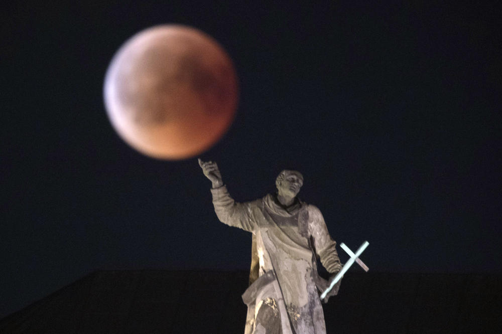 The moon turns red during a total lunar eclipse, behind the Saentis in Luzern, Switzerland, on July 27, 2018. (Christian Merz/Keystone via AP)The moon turns red during a total lunar eclipse, as seen from Dresden, Germany, on July 27, 2018. (Sebastian Kahnert/dpa via AP)