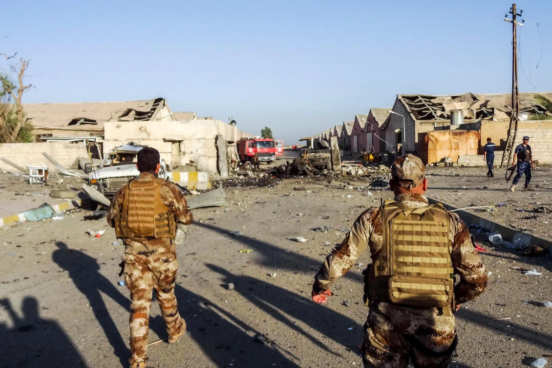 Members of the Iraqi Counter-Terrorism Service arrive at the scene of an attack outside warehouses where ballots from the May 12 parliamentary vote were stored in Kirkuk on Sunday, July 1. (AFP)