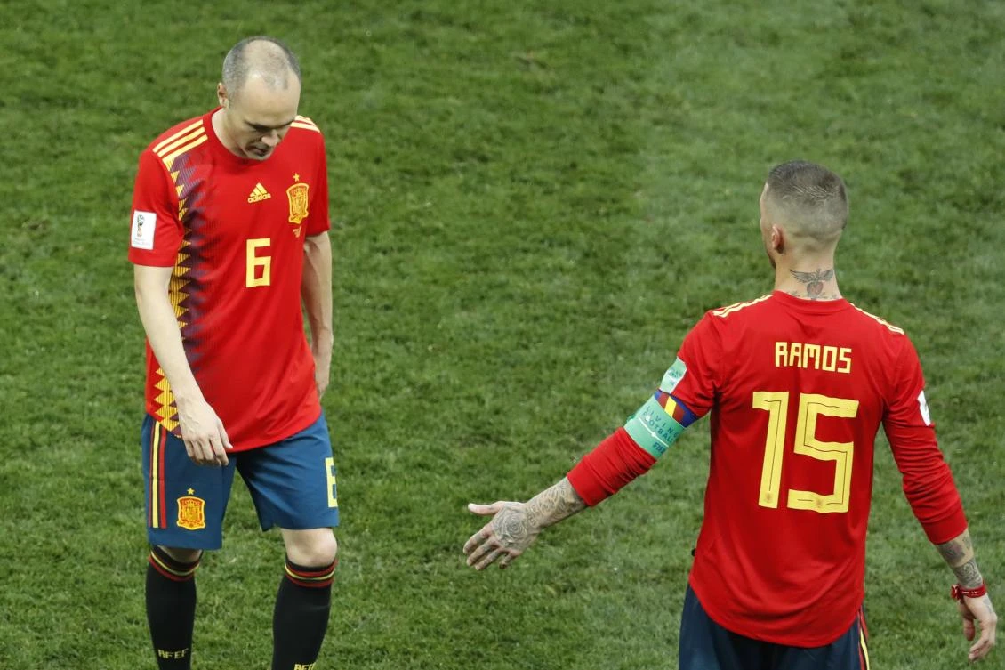 Spain's Andres Iniesta, left, leaves the pitch after the round of 16 match between Spain and Russia at the 2018 soccer World Cup at the Luzhniki Stadium in Moscow, Russia, Sunday, July 1, 2018. Russia eliminates Spain 4-2 on penalties after game ends 1-1. (AP Photo/David Vincent)