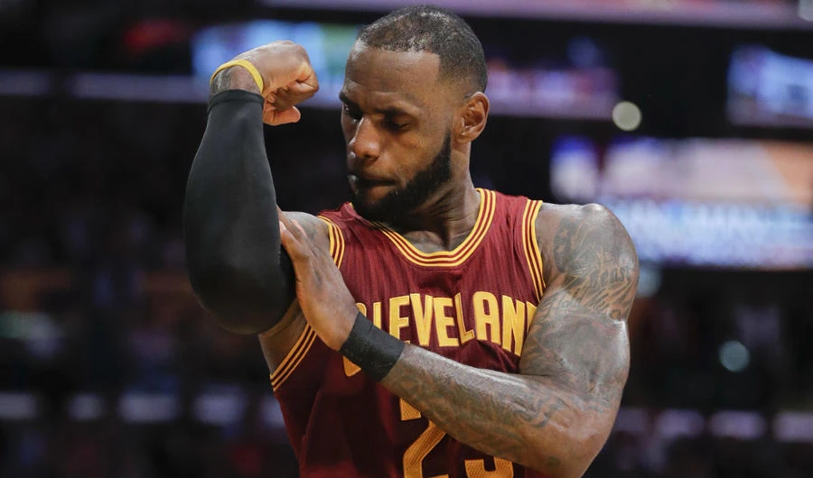 In this March 19, 2017, file photo, Cleveland Cavaliers' LeBron James flexes his arm after making a basket and drawing a foul call against the Los Angeles Lakers during the second half of an NBA basketball game in Los Angeles. (AP Photo/Jae C. Hong, File)