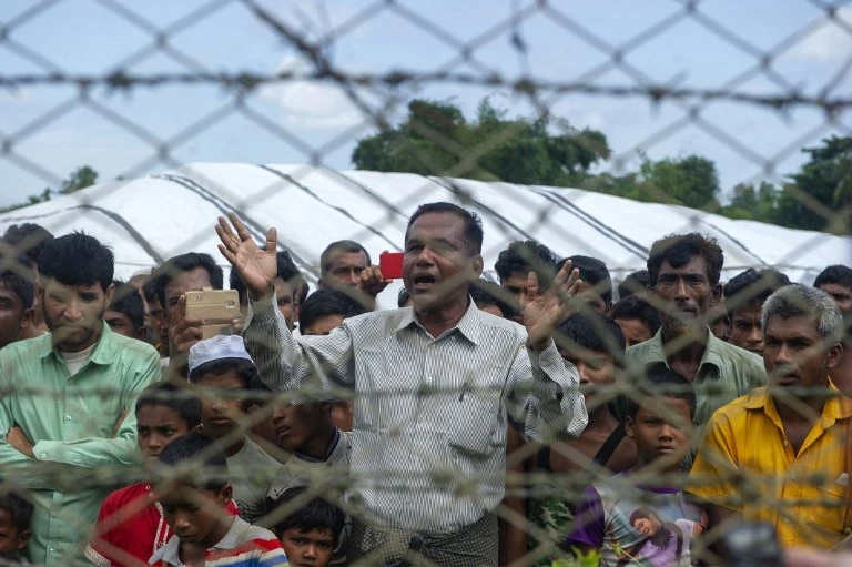Rohingya refugees gather near the fence in the "no man's land" between Myanmar and Bangladesh border as seen from Maungdaw, Rakhine state, on June 29, 2018. (AFP)