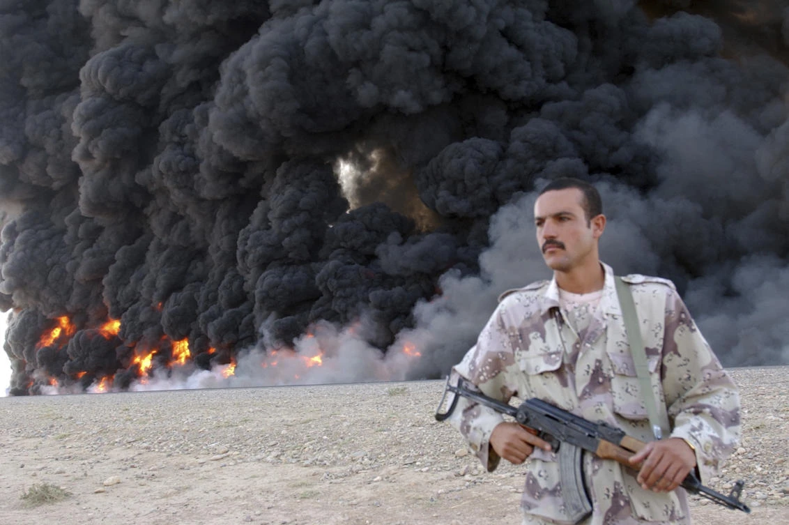 Above, an Iraqi soldier secures a burning pipeline near Kirkuk, 290 kilometers north of Baghdad in this 2005 photo. (AP)