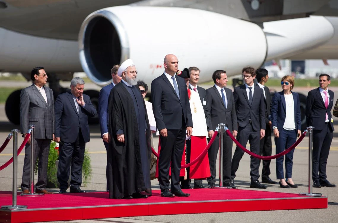 Iranian President Hassan Rohani (L) stands with Swiss Federal President Alain Berset as they listen to the playing of national anthems after disembarking from an aircraft after his arrival at an airport in Kloten — Zurich Canton — on July 2, 2018, during an official visit to Switzerland. (AFP)