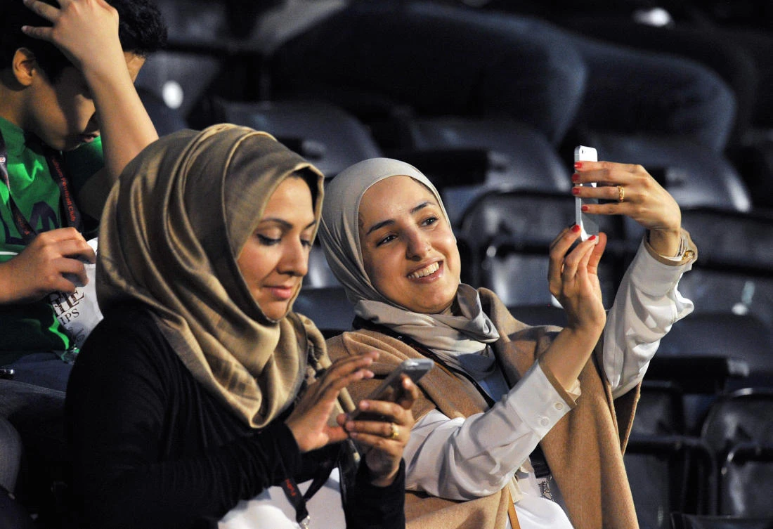 Saudi fans use their mobile phones before the start of an international friendly football match between Saudi Arabia and Australia at Craven Cottage in London. The highest surges in Twitter traffic coincide with sporting events and breaking news. (AFP)