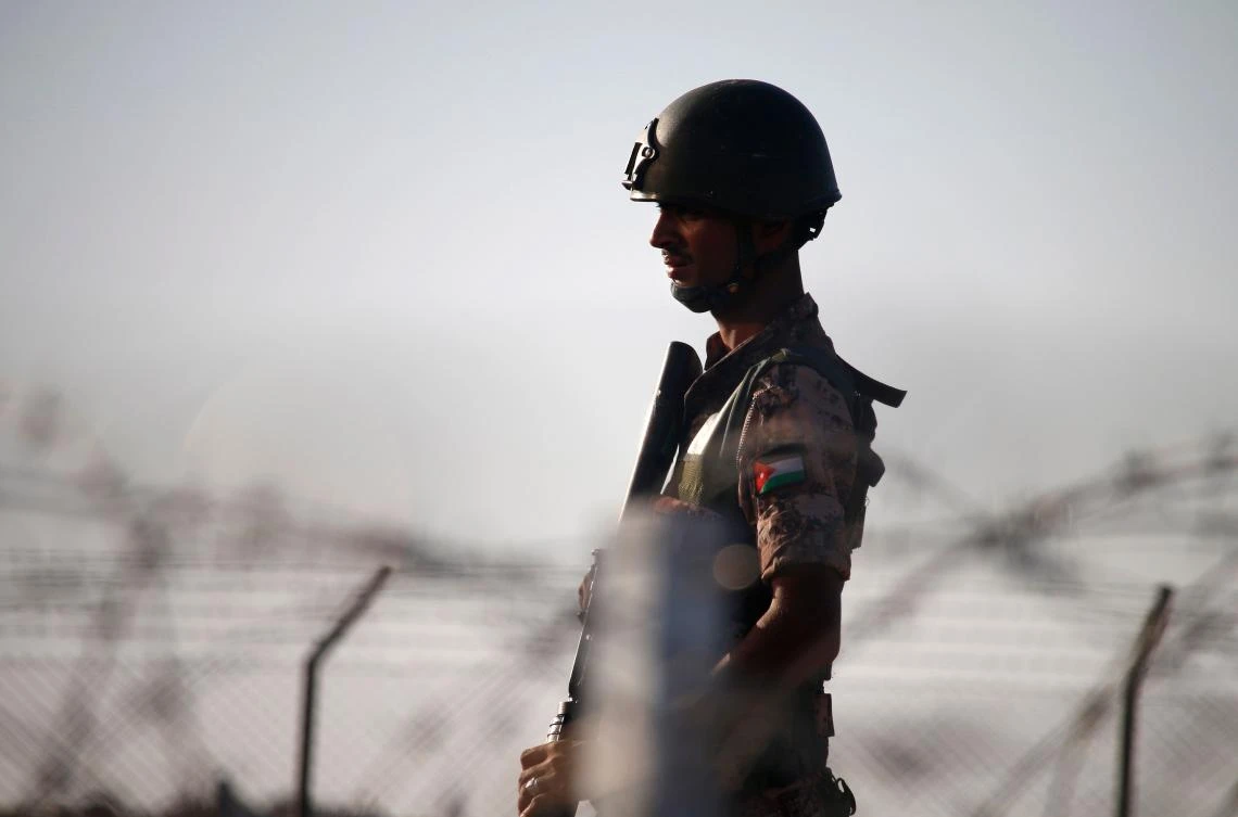 A Jordanian soldier keeps watch at the border between Syria and Jordan, near the town of Nasib in southern Syria, on July 2, 2018. (AFP/Mohamad ABAZEED)