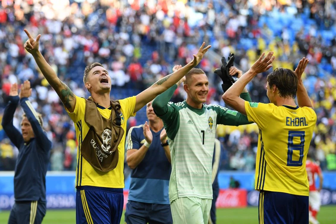Sweden's goalkeeper Robin Olsen (C), Sweden's midfielder Albin Ekdal (R) and teammates celebrate their victory at the end of the match between Sweden and Switzerland. (AFP/Paul ELLIS)