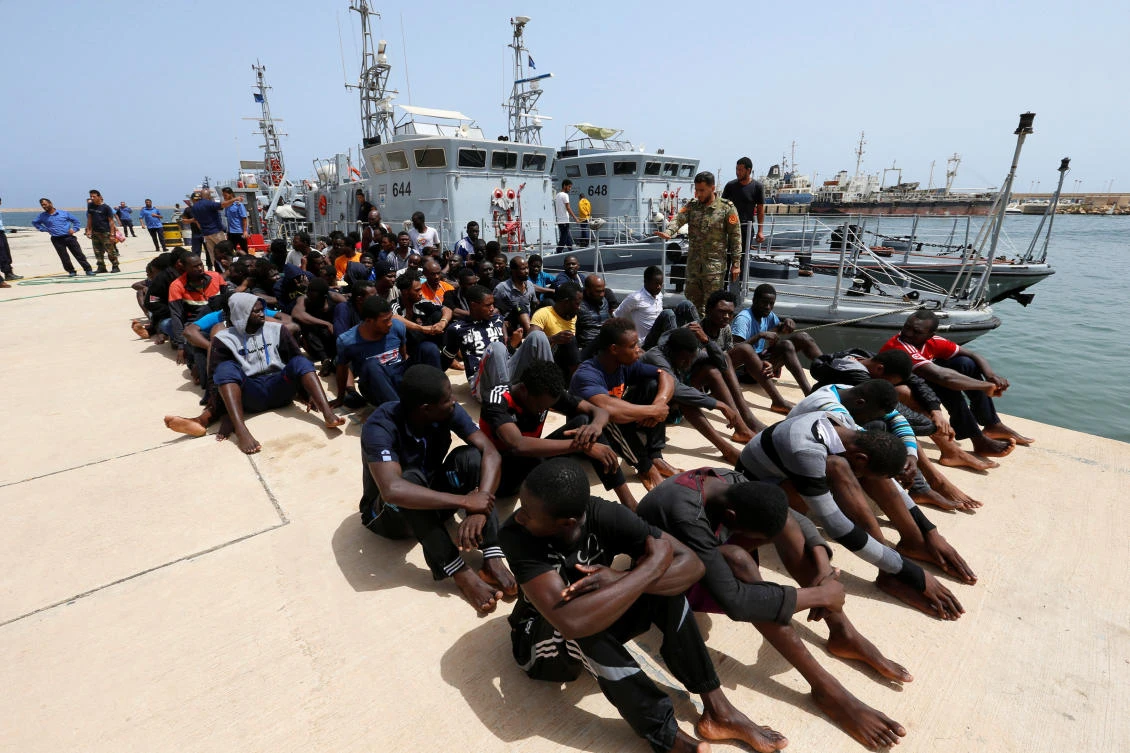Migrants sit at a naval base after being rescued by the Libyan coastguard in Tripoli. Italy is ready to assist the Libyan coastguard in tackling the North African country’s migrant crisis. (Reuters)