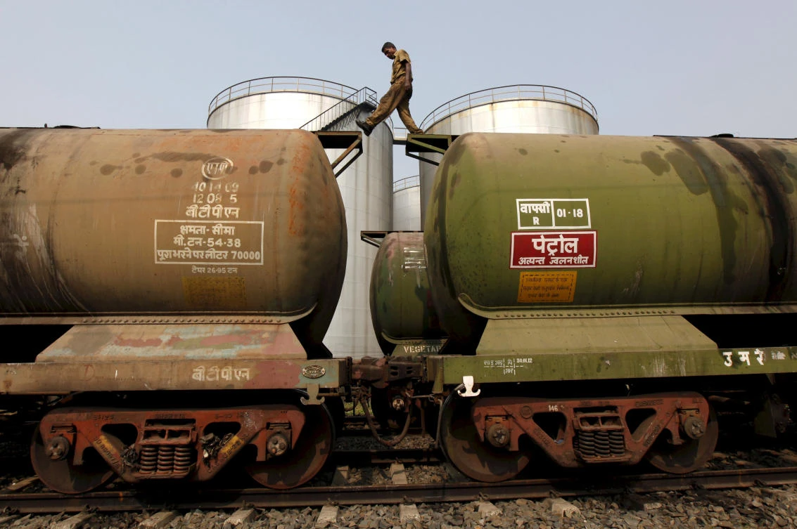 A worker walks atop a tanker wagon to check the freight level at an oil terminal on the outskirts of Kolkata. India is the biggest buyer of Iranian oil after China. (Reuters)
