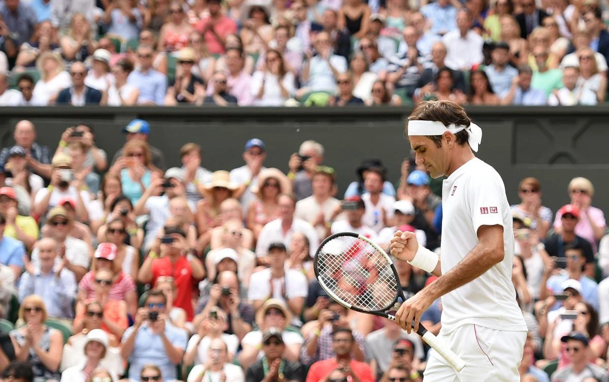 Switzerland's Roger Federer reacts after winning against Slovakia's Lukas Lacko during their men's singles second round match on the third day of the 2018 Wimbledon Championships. (AFP/Oli SCARFF)