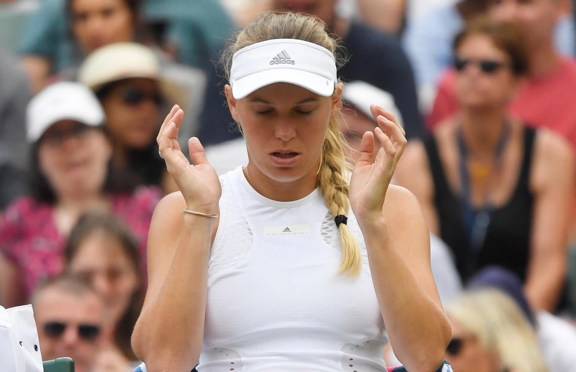 Second seed Caroline Wozniacki crashes out, Serena Williams marches on at Wimbledon