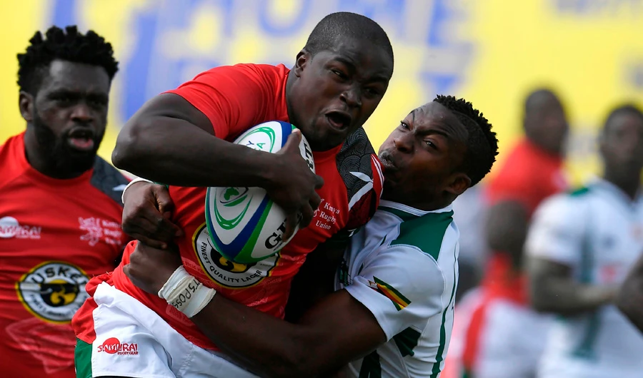 Zimbabwe's Lenience Tambwera (R) tackles Kenya's Isaac Adimo during the 2018 Rugby African Gold Cup match between Kenya and Zimbabwe in Nairobi on June 30, 2018, which acts a qualifier for the 2019 Rugby World Cup in Japan. Kenya won 45-36. (AFP / SIMON MAINA)