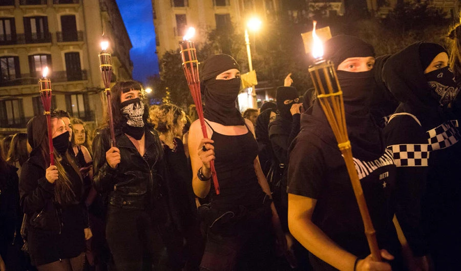Women covering their faces with black scarves demonstrate, demanding women rights in Pamplona, on July 4, 2018, two days before the start of the San Fermin festival, which draws tens of thousands of visitors. (AFP / ANDER GILLENEA)
