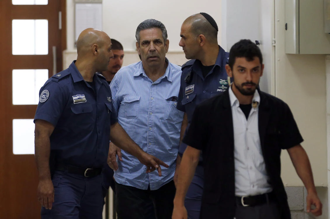 Former Israeli cabinet minister indicted on suspicion of spying for Iran, Gonen Segev, centre, is escorted by prison guards as he arrives at court in Jerusalem, Israel, Thursday July 5, 2018. (AP)