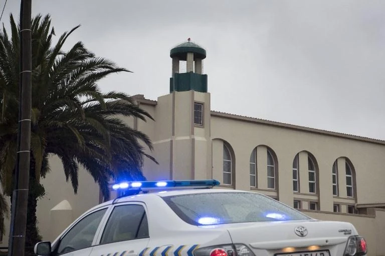 A police vehicle stands in front of the mosque following a stabbing attack that left two worshippers dead and the attacker shot by the police on June 14, 2018 in Malmesbury, an agricultural town about 50Km north of Cape Town. (AFP)